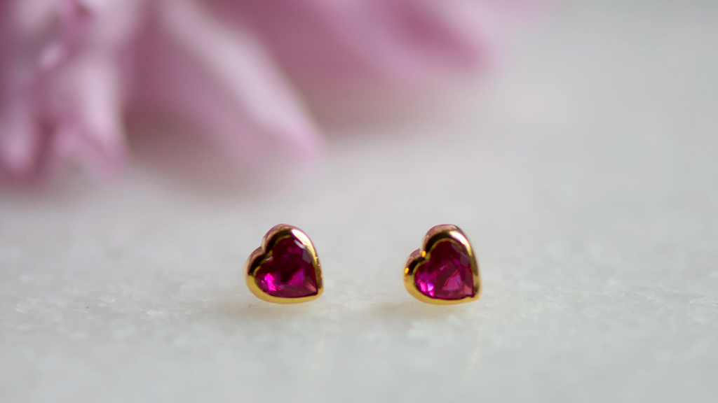 Inspired by Love | Heart shaped ear stud with a ruby cubic zirconia gemstone.