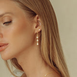 The Y Drop Necklace in Gold paired with the triple Drops in Zirconia