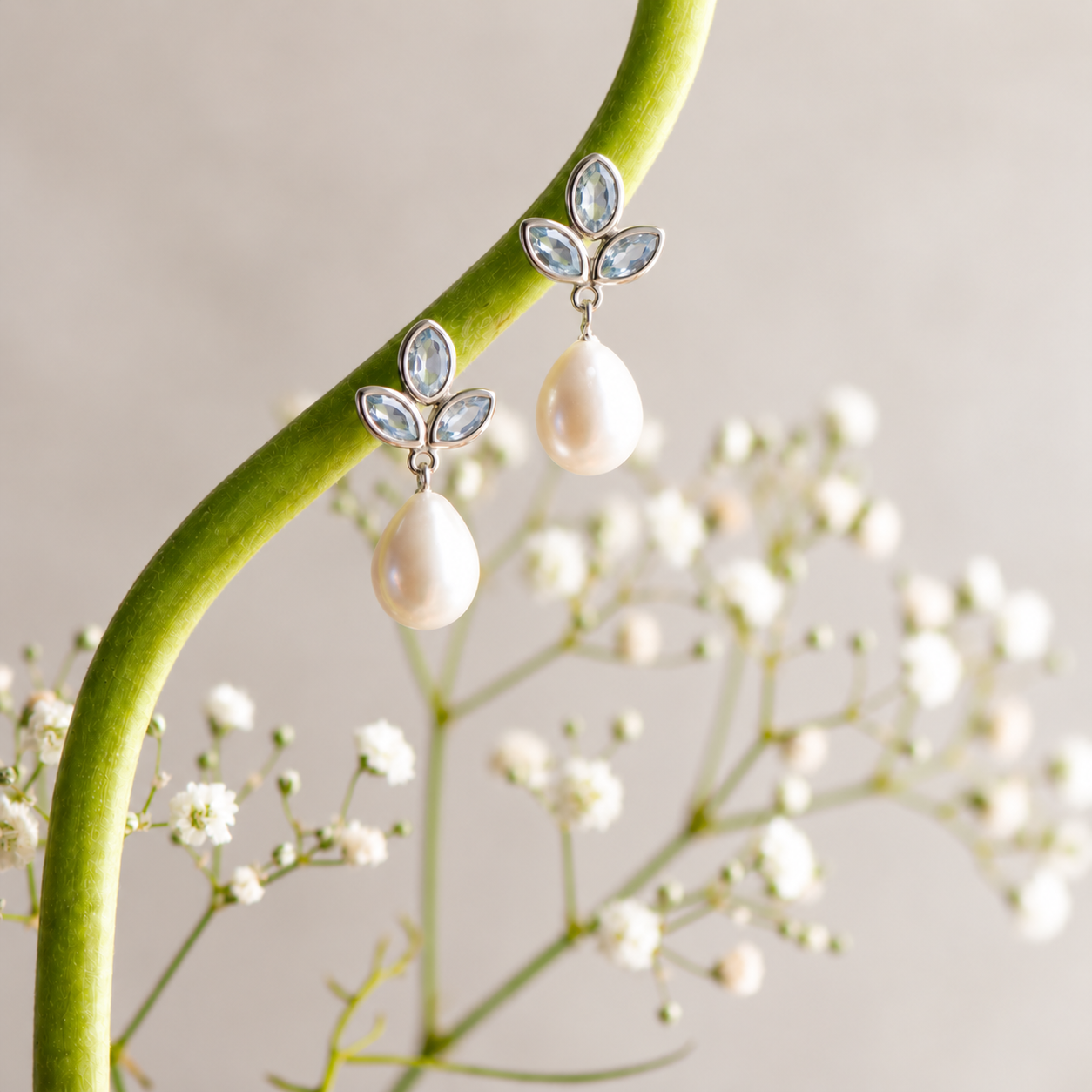 Pearl drop earring with three leaf shaped topaz stones from Memara